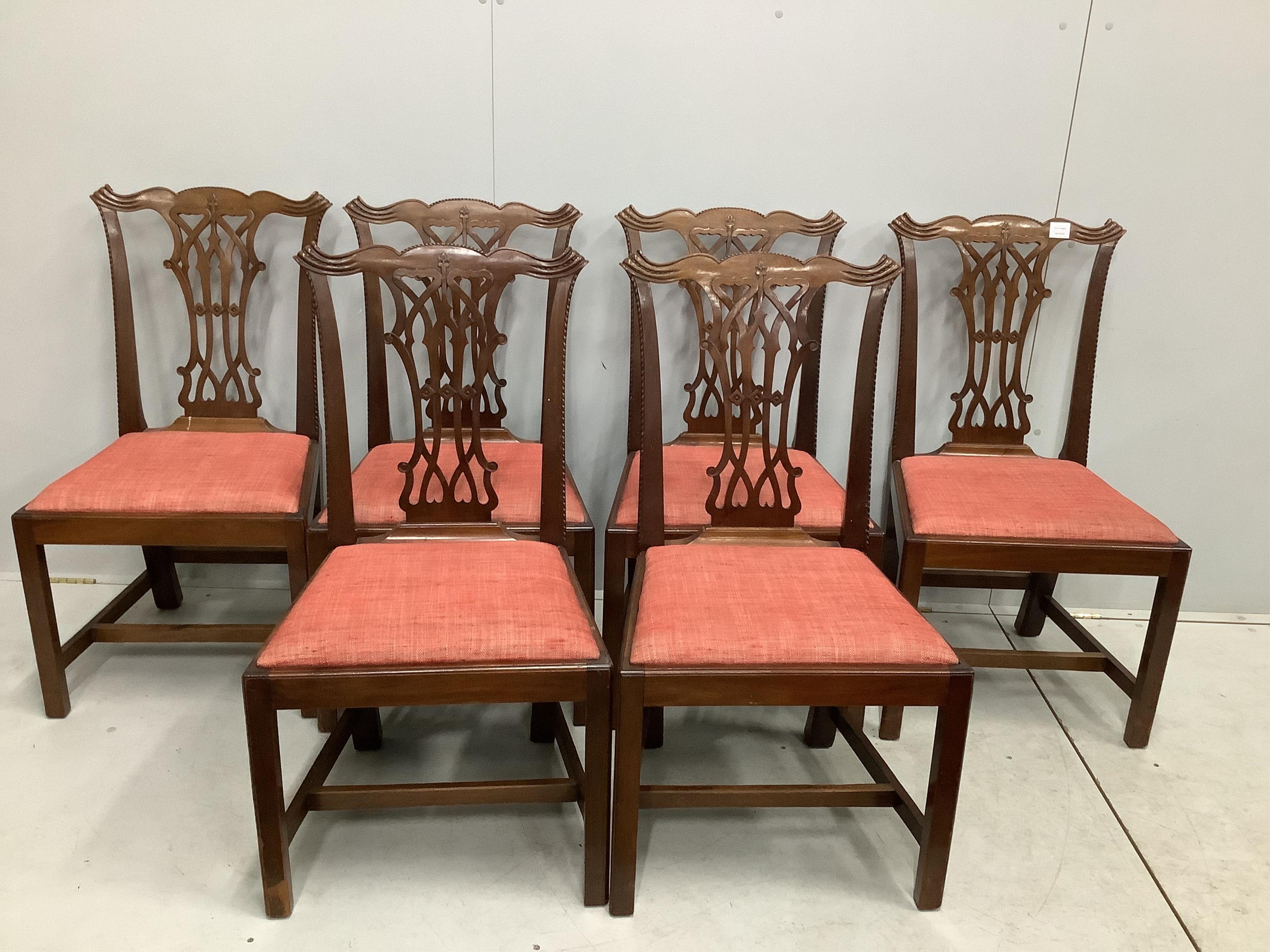 A set of six George III style mahogany Chippendale design dining chairs, with pierced splats, over drop-in seats and H stretchers. Condition - fair to good